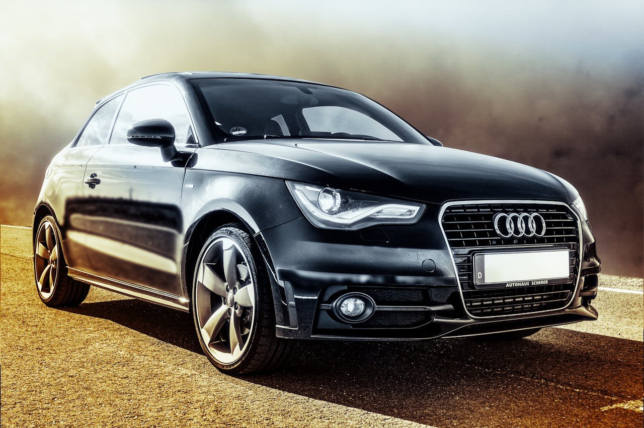 High-quality image of a sleek black luxury coupe on an empty road, showcasing elegance and power.